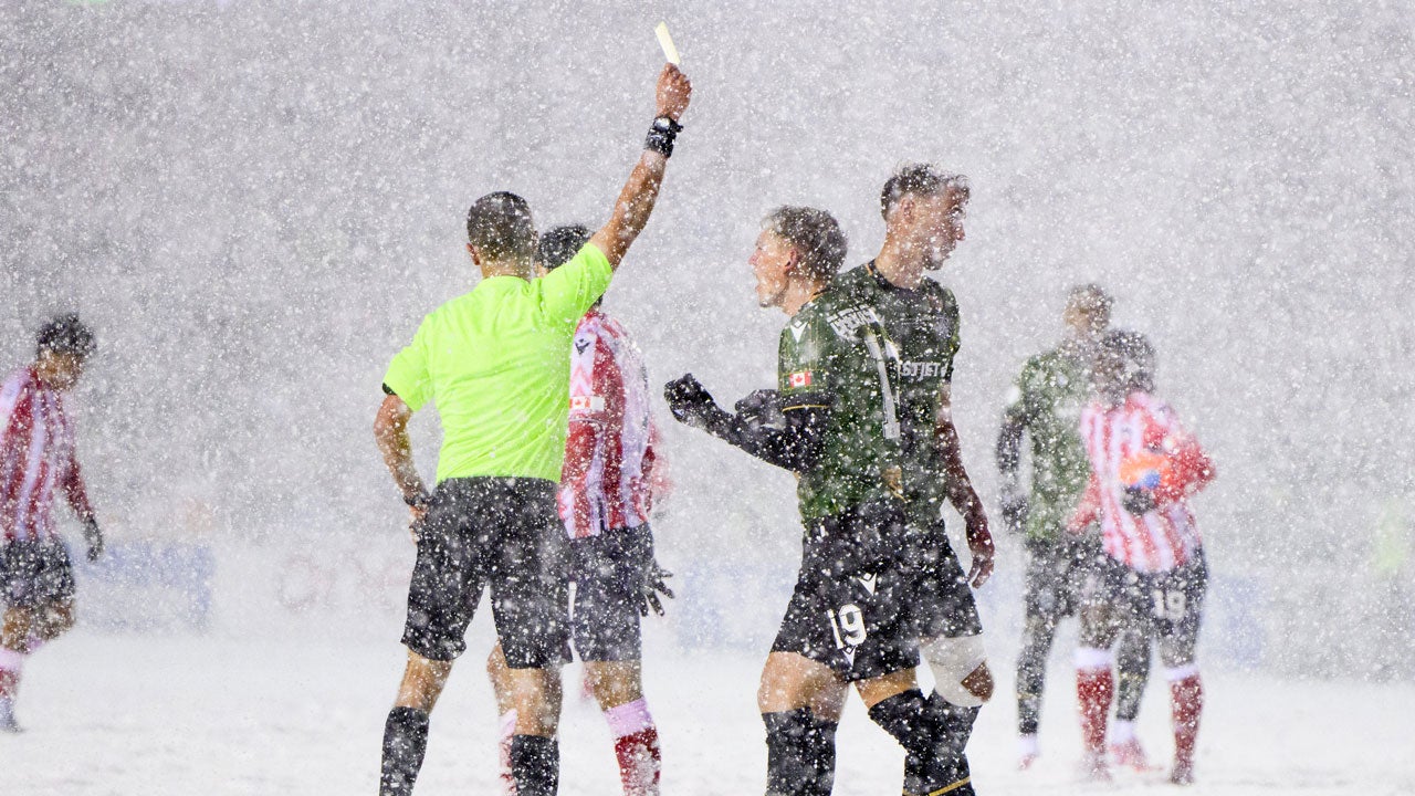 Cavalry FC's Mihail Gherasimencov (19) complains to a referee, center left, after being issued a yellow card during second-half Canadian Premier League finals soccer match action against Atletico Ottawa in Ottawa, Ontario, Sunday, Nov. 9, 2025. (Spencer Colby/The Canadian Press via AP)