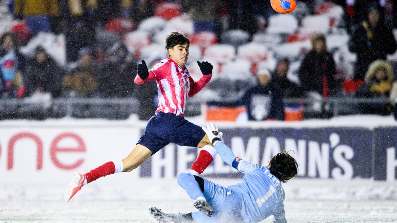 Atletico Ottawa's David Rodr&iacute;guez (7) scores on Cavalry FC's Ali Musse (7) during extra time Canadian Premier League finals soccer action in Ottawa, on Sunday, Nov. 9, 2025. (Spencer Colby/The Canadian Press via AP)