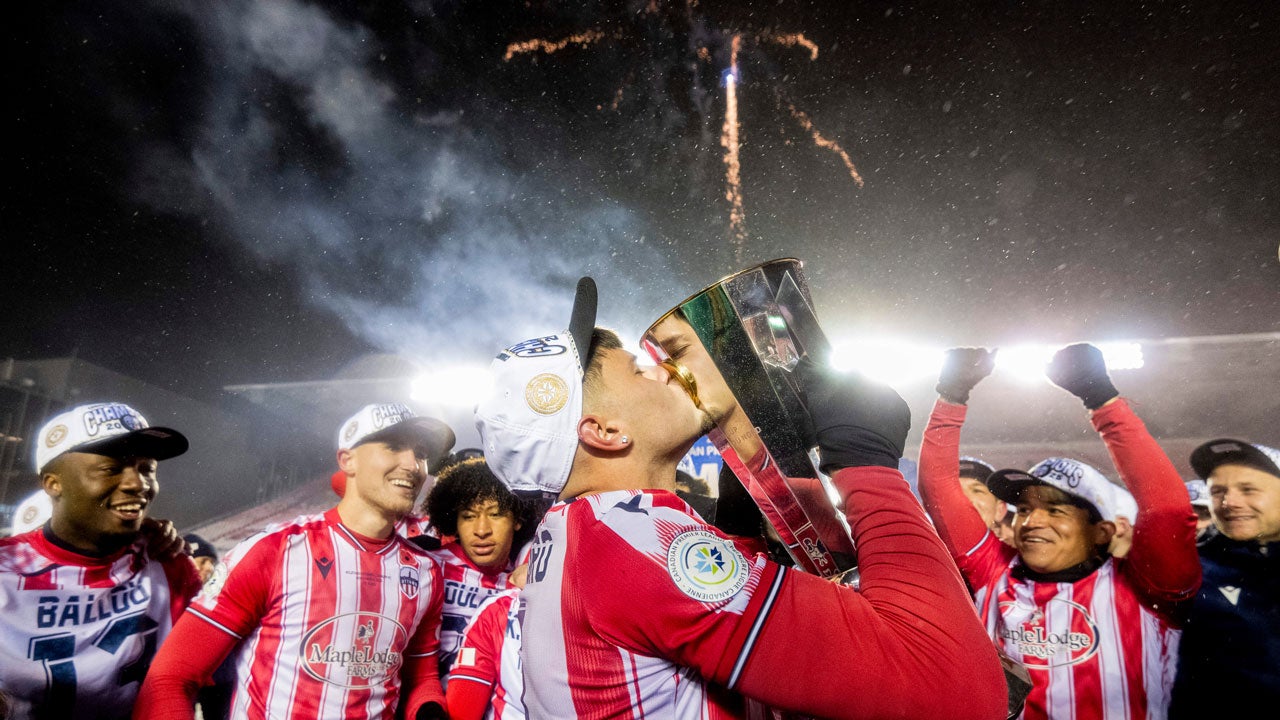 Atletico Ottawa's Gabriel Mendes Antinoro (11) kisses the North Star Cup following Atletico Ottawa's victory over Cavalry FC in extra time during the Canadian Premier League finals soccer action in Ottawa, on Sunday, Nov. 9, 2025. (Spencer Colby/The Canadian Press via AP)