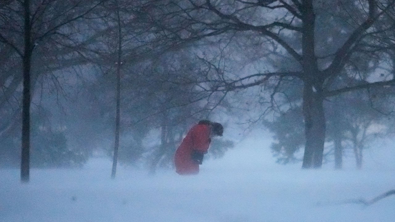 A person walks against the blowing snow Saturday, Nov. 29, 2025, in Chicago. (AP Photo/Kiichiro Sato)