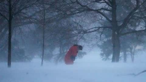 A person walks against the blowing snow Saturday, Nov. 29, 2025, in Chicago. (AP Photo/Kiichiro Sato)