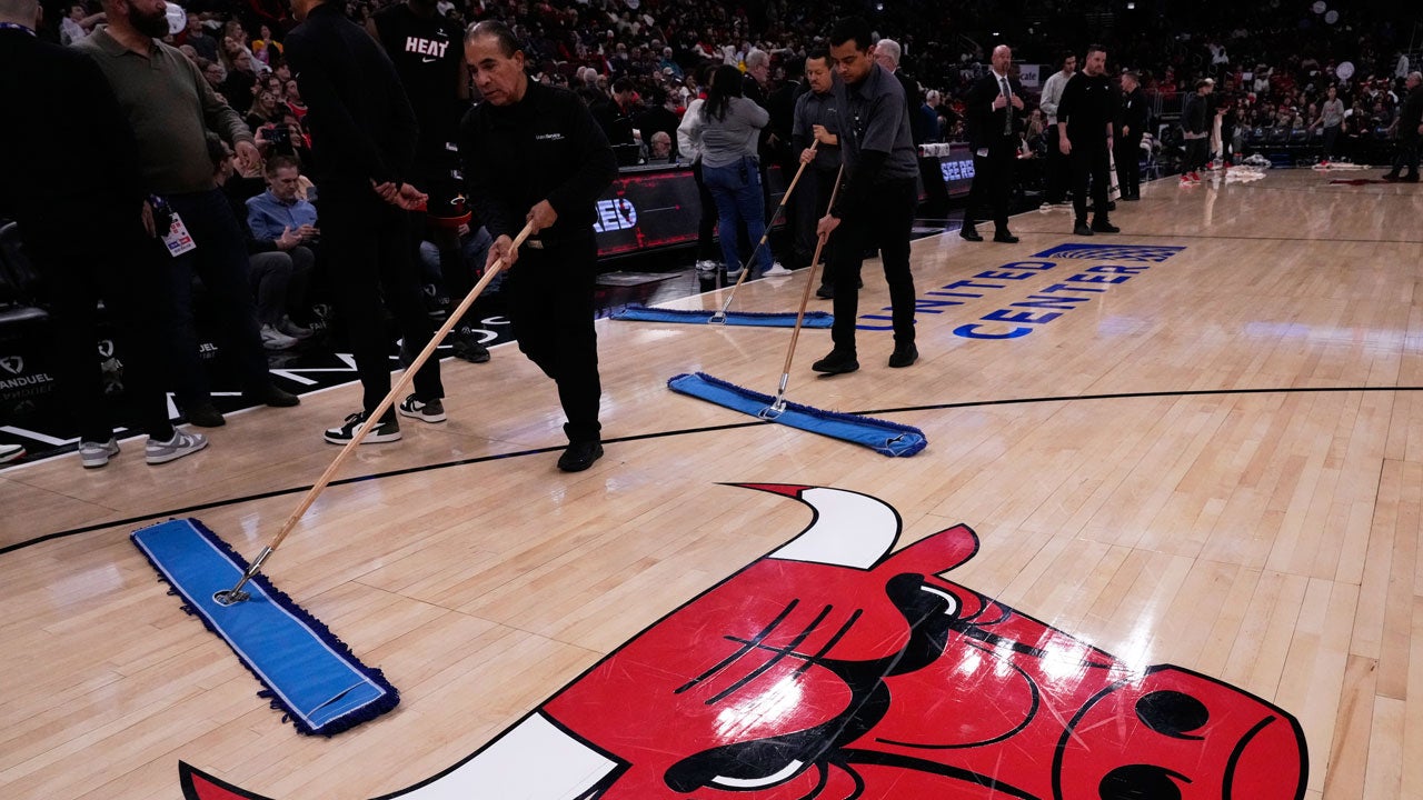 United Center employees try to dry the court before an NBA basketball game between the Miami Heat and the Chicago Bulls in Chicago, Thursday, Jan. 8, 2026. (AP Photo/Nam Y. Huh)