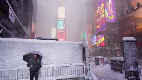 Pedestrians navigate deep snow in Times Square, New York City, amid Winter Storm Hernando
