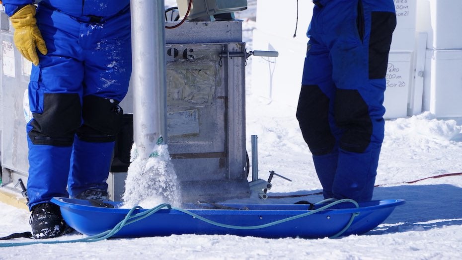 After pulling the drilling piece up, excess ‘snow’ from the drilling process is removed