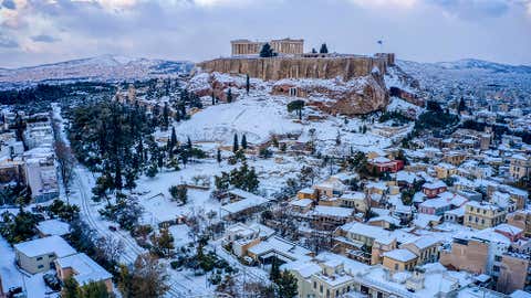 The city of Athens with the ancient Acropolis hill is covered with snow after heavy snowfall on Tuesday, January 25, 2022. A snowstorm of rare severity disrupted road and air traffic Monday in the Greek capital, while most of Greece, including — unusually — several Aegean islands, was blanketed by snow. (Antonis Nikolopoulos/Eurokinissi via AP)