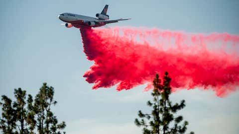 A DC-10 air tanker drops retardant while battling the Salt Fire near the Lakehead community in Shasta County, California, on July 2, 2021. (AP Photo/Noah Berger)