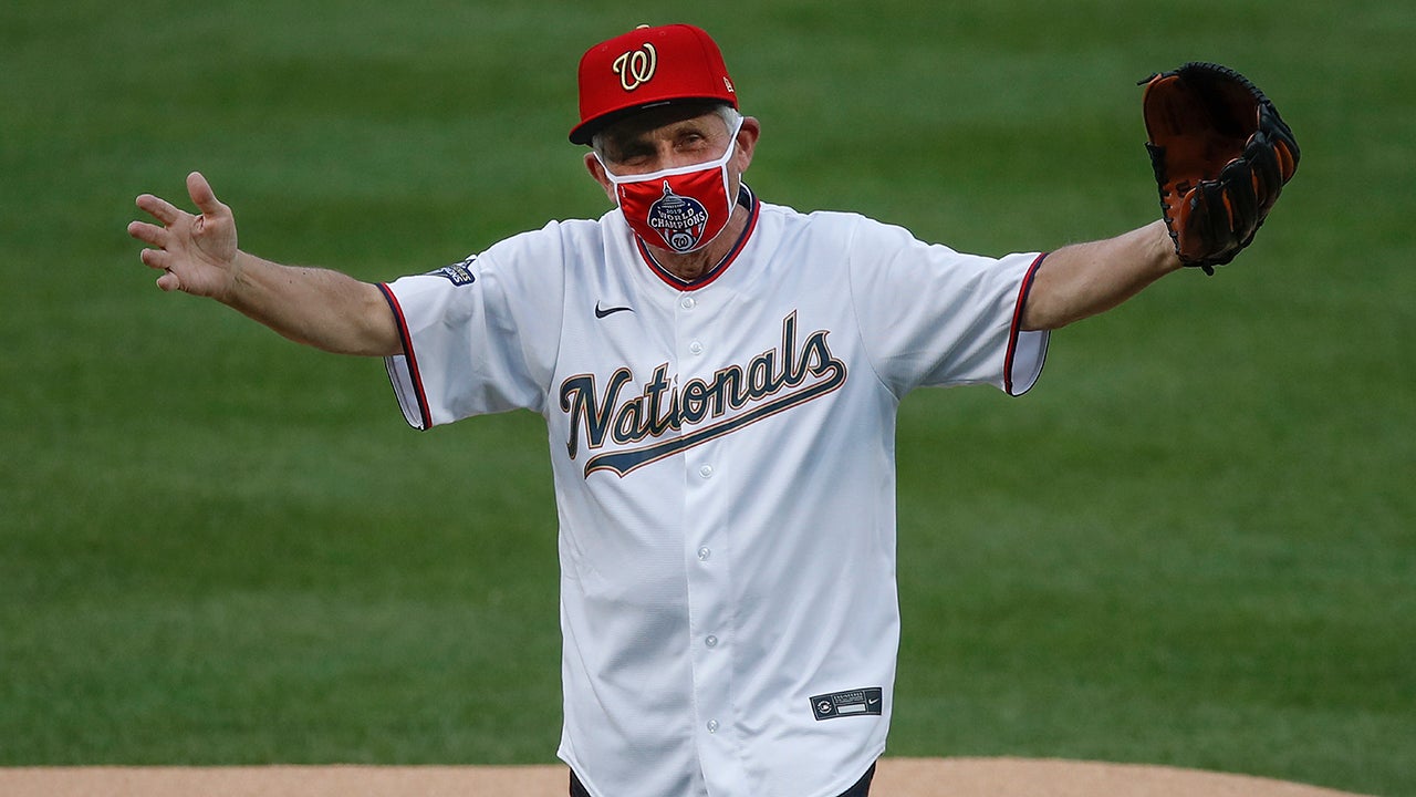 Dr. Anthony Fauci, director of the National Institute of Allergy and Infectious Diseases, reacts after throwing out the ceremonial first pitch before the start of the first inning of an opening day baseball game between the New York Yankees and Washington Nationals at Nationals Park in Washington on Thursday, July 23, 2020. (AP Photo/Alex Brandon)