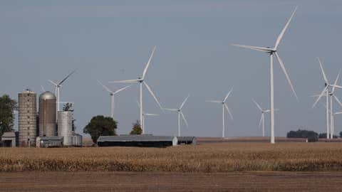 RIPPEY, IOWA - OCTOBER 14: Wind turbines are seen in a corn field behind a farm on October 14, 2019 in Rippey, Iowa. The 2020 Iowa Democratic caucuses will take place on February 3, 2020, making it the first nominating contest in the Democratic Party presidential primaries. (Photo by Joe Raedle/Getty Images)