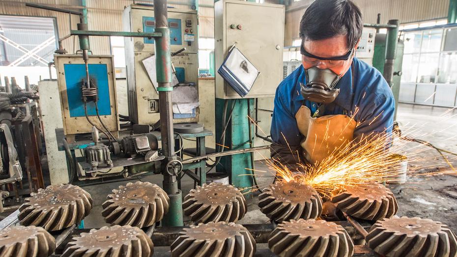 A factory worker back on the job on March 2, 2020, in Weifang, China