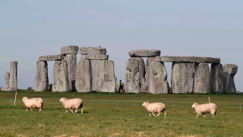 TOPSHOT - Sheep graze as security guards patrol the prehistoric monument at Stonehenge in southern England, on April 26, 2020, closed during the national lockdown due to the novel coronavirus COVID-19 pandemic. - Britain's health ministry on Saturday said 813 more people had died after testing positive for COVID-19 in hospital, taking the death toll to 20,319. (Photo by Adrian DENNIS / AFP) (Photo by ADRIAN DENNIS/AFP via Getty Images)