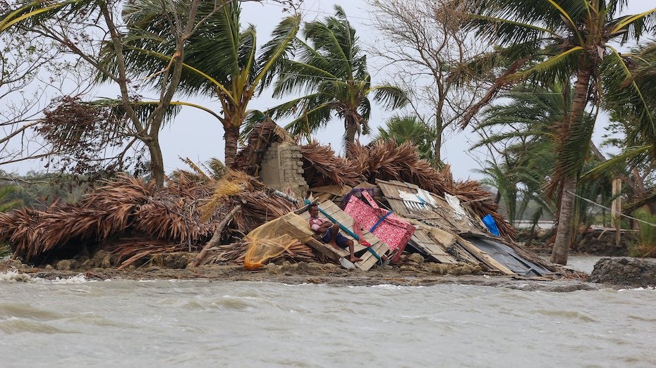 Man resting on debris from Cyclone Amphan in Koyra, Bangladesh, 5/27/20