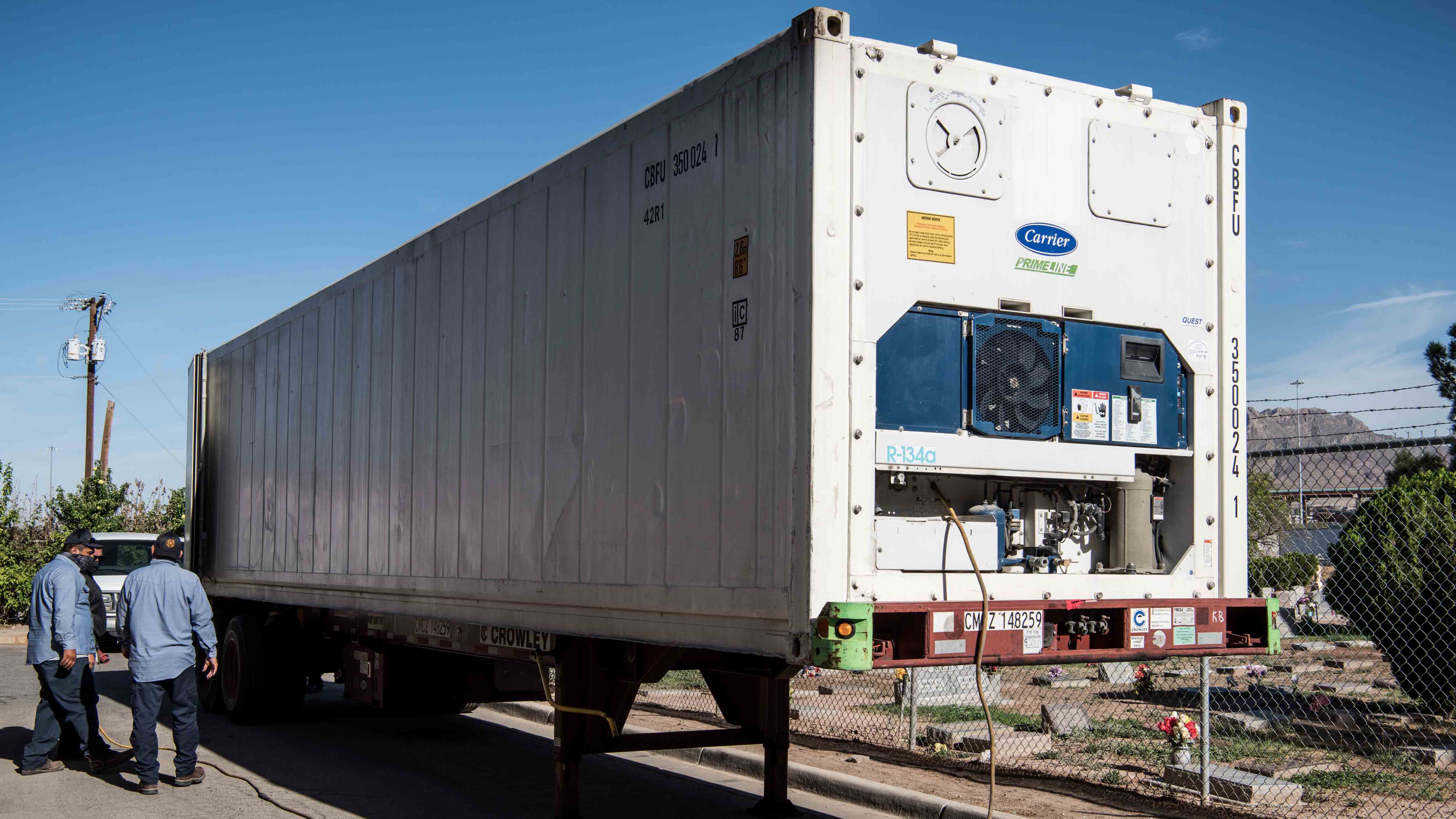 EL PASO, TX - JULY 21: Men unload a mobile morgue outside the El Paso County Office of the Medical Examiner on July 21, 2020 in El Paso, Texas. As coronavirus deaths surge past 4000 in Texas, overwhelmed hospitals are being forced to plan for extra refrigerated storage to hold deceased patients.(Photo by Cengiz Yar/Getty Images)