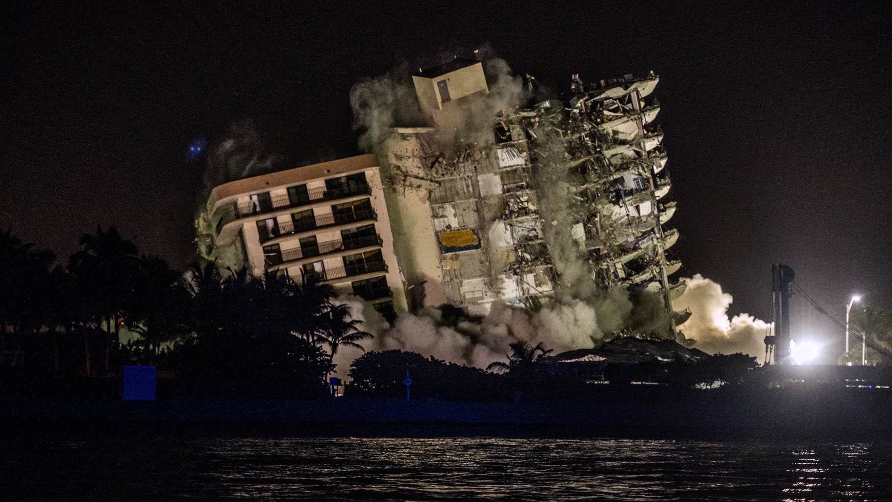 The rest of Champlain Towers South is seen being demolished in Surfside, Florida, north of Miami Beach, late July 4, 2021. A controlled explosion brought down the unstable remains of the collapsed apartment block ahead of Tropical Storm Elsa as rescuers prepared to resume searching for victims. (GIORGIO VIERA/AFP via Getty Images)