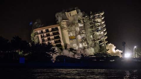 The rest of Champlain Towers South is seen being demolished in Surfside, Florida, north of Miami Beach, late July 4, 2021. A controlled explosion brought down the unstable remains of the collapsed apartment block ahead of Tropical Storm Elsa as rescuers prepared to resume searching for victims. (GIORGIO VIERA/AFP via Getty Images)
