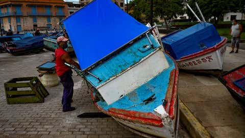 Fishermen secure their boats to land ahead of the passage of Tropical Storm Elsa in Havana on July 5, 2021. (YAMIL LAGE/AFP via Getty Images)