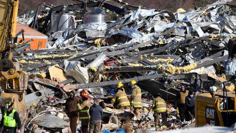 Emergency workers search through what is left of the Mayfield Consumer Products Candle Factory after it was destroyed by a tornado in Mayfield, Kentucky, on December 11, 2021. (Photo by John Amis / AFP) (Photo by JOHN AMIS/AFP via Getty Images)