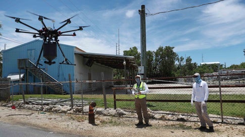 KEY LARGO, FLORIDA - JULY 08: Bruce Stevens and Chris Law (L-R) from the Florida Keys mosquito control department use a drone loaded with BTI larvicide to spread it over an area as they work to eradicate mosquitos carrying dengue fever on July 8, 2020 in Key Largo, Florida. 11 cases of dengue fever have been confirmed in the Florida Keys and all have been in Key Largo. The disease is transmitted through the bite of the female Aedes aegypti mosquito. Officials are asking residents to help stop the spread of the disease by eliminating potential Aedes aegypti breeding grounds. This includes cleaning gutters and dumping standing water in empty pots, buckets trash cans and pet bowls. (Photo by Joe Raedle/Getty Images)