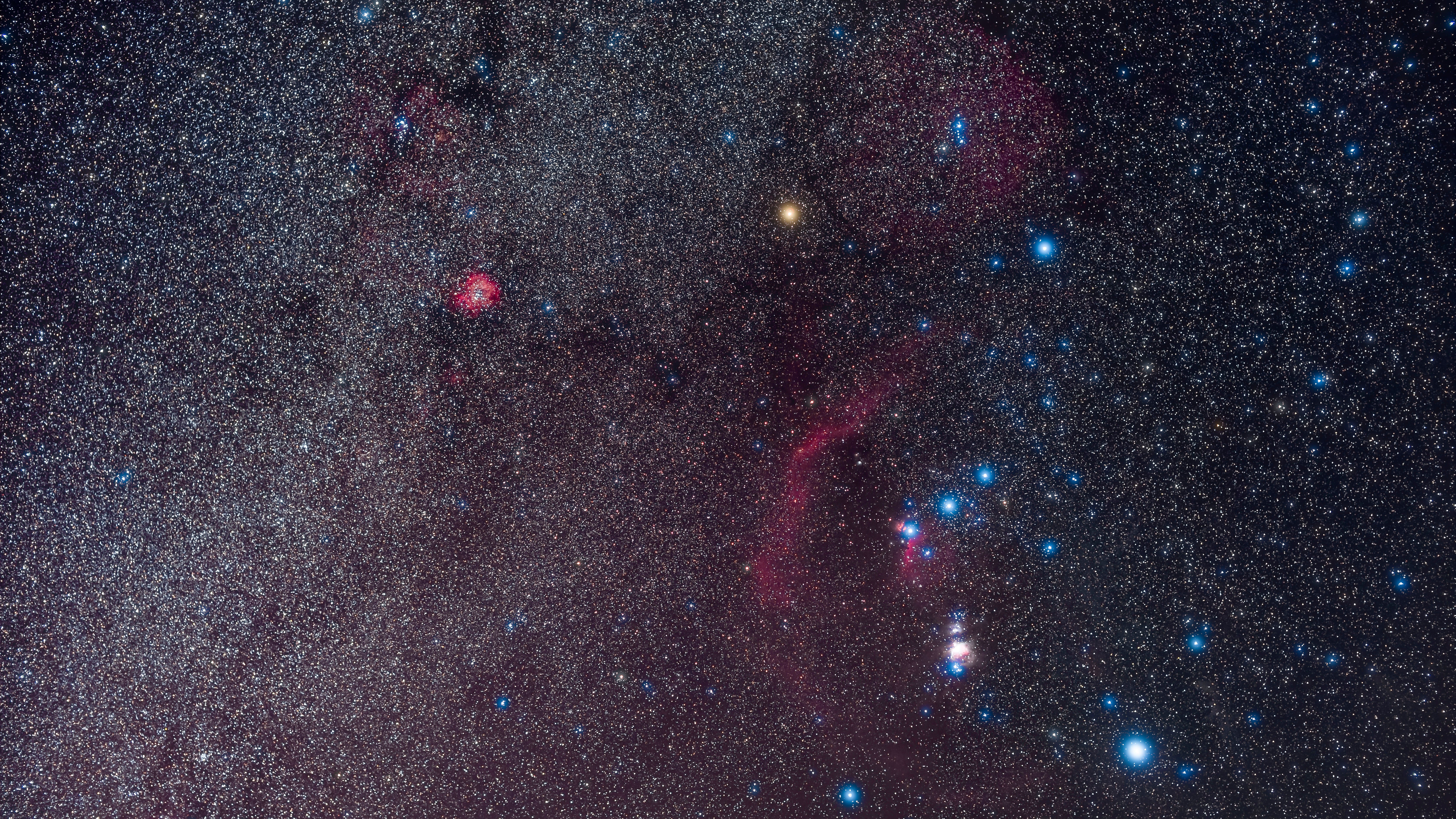 A portrait of Orion and the northern winter Milky Way, on a February night, 2020. The Orion Nebula is the bright, overexposed pink glow below the Belt of Orion, while the curving arc of red is Barnard&rsquo;s Loop, now thought to be a supernova remnant. The bright red glow at upper left is the Rosette Nebula. Red Betelgeuse was at its minimum then, at about the same brightness as Bellatrix to the right &mdash; Betelgeuse is usually about as bright as blue-white Rigel at lower right. However, Betelguese began to re-brighten in the nights after this. This is a stack of 8 x 2-minute exposures at ISO 800 with no filter and 6 x 3-minute exposures at ISO 1250 with a NISI Natural Night light pollution filter, all with the Sigma 50mm lens at f/3.2 and red-sensitive Canon EOS Ra camera on the iOptron SkyGuider Pro tracker. An additional exposure without the NISI but through a Kenko Softon A diffusion filter adds the star glows. Taken from home in Alberta on February 24, 2020. (Photo by: Alan Dyer/VW PICS/Universal Images Group via Getty Images)
