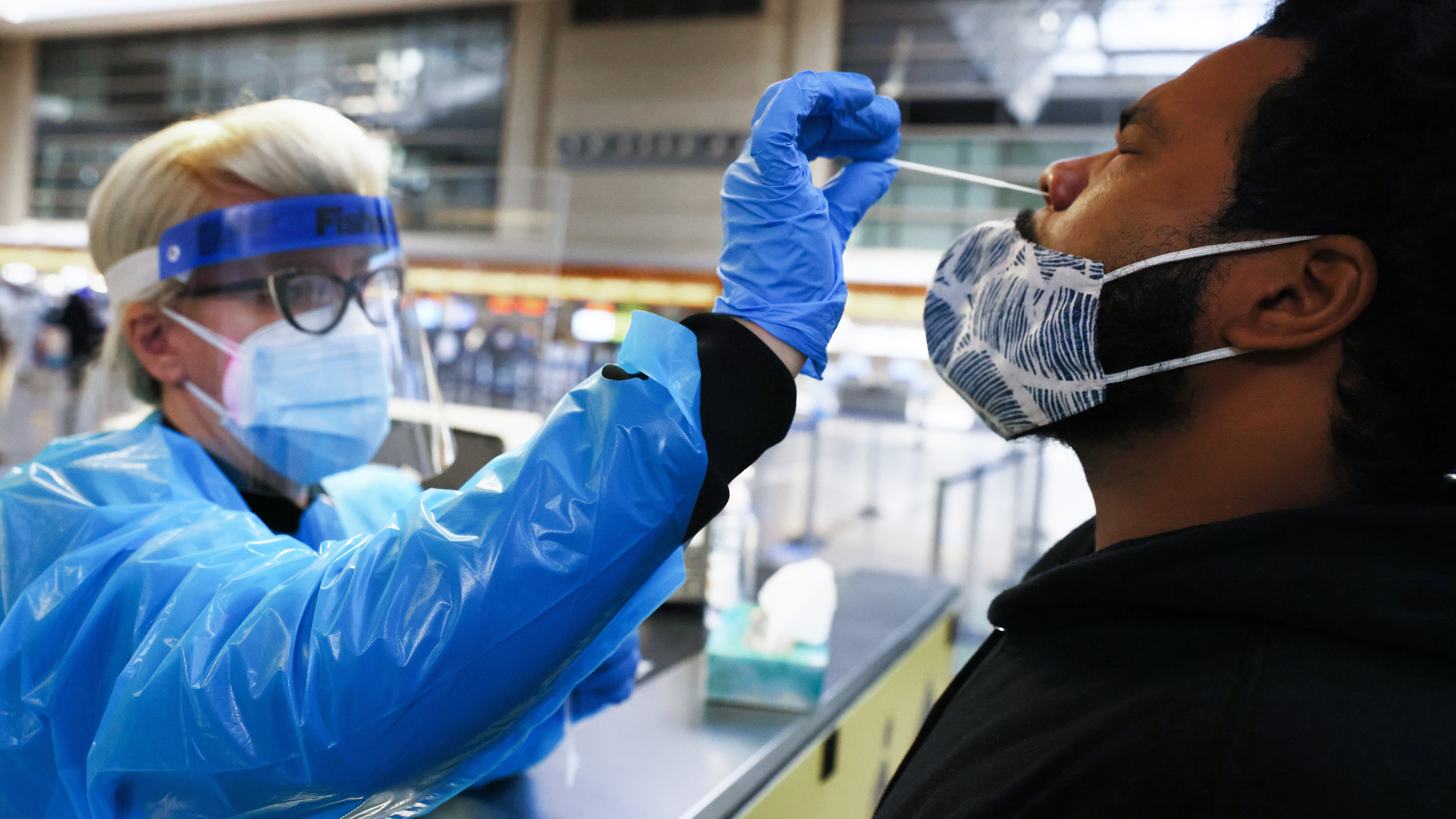 A man receives a nasal swab COVID-19 test at Tom Bradley International Terminal at Los Angeles International Airport (LAX) amid a coronavirus surge in Southern California on Dec. 22, 2020, Los Angeles, Calif. The tests are not mandatory with results returned within 24 hours to help travelers avoid quarantining at their destinations. TSA agents screened over 1 million people for three consecutive days last Friday, Saturday and Sunday, the beginning of the traditional holiday travel season, for the first time since the start of the coronavirus pandemic. (Mario Tama/Getty Images)