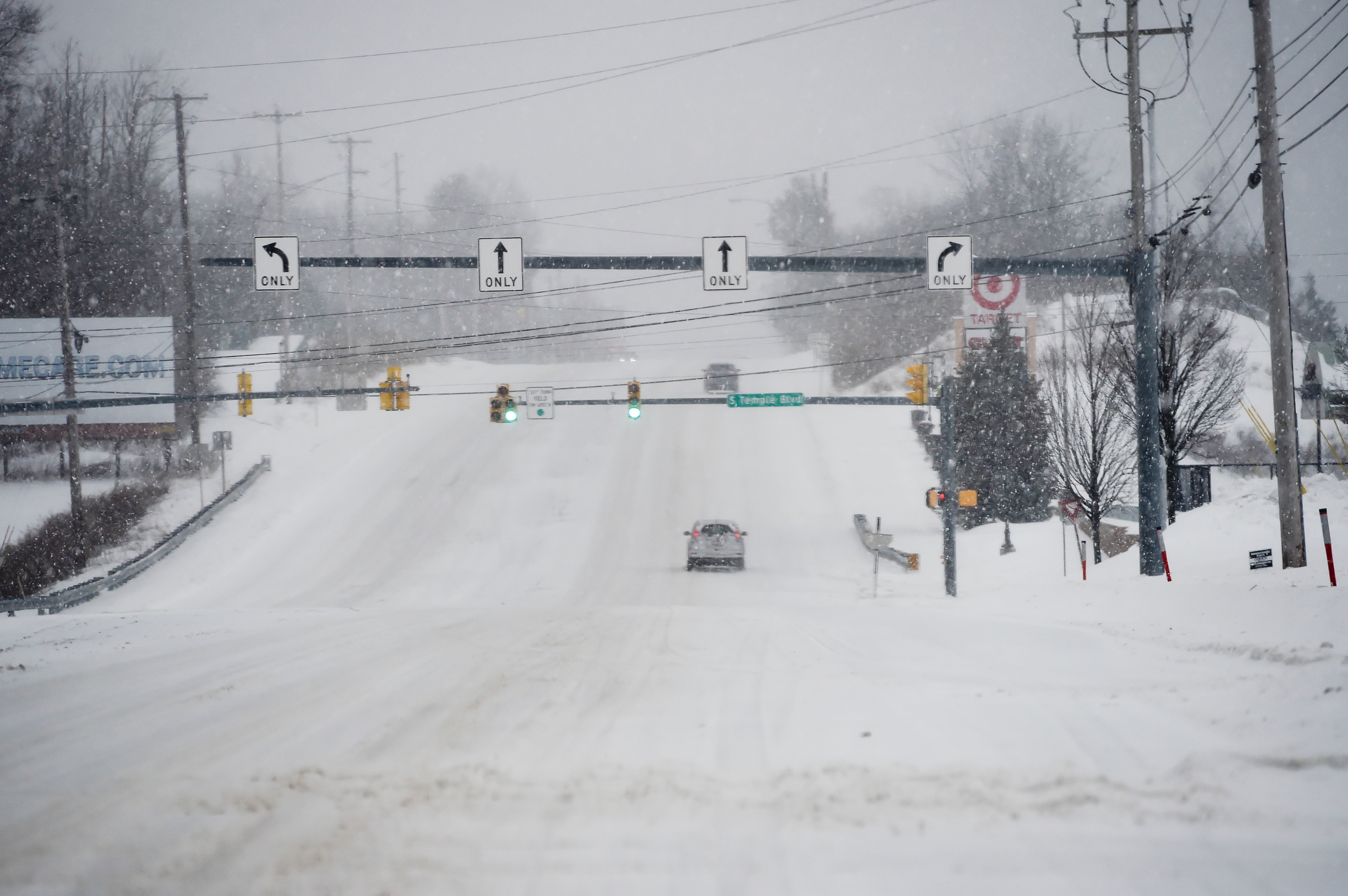 Cars drive on a snow covered 5th Street Highway in Muhlenberg Township, Pa., on Monday, Feb. 1, 2021, during a nor'easter that hit the East Coast with heavy snow and winter weather. (Ben Hasty/MediaNews Group/Reading Eagle via Getty Images)