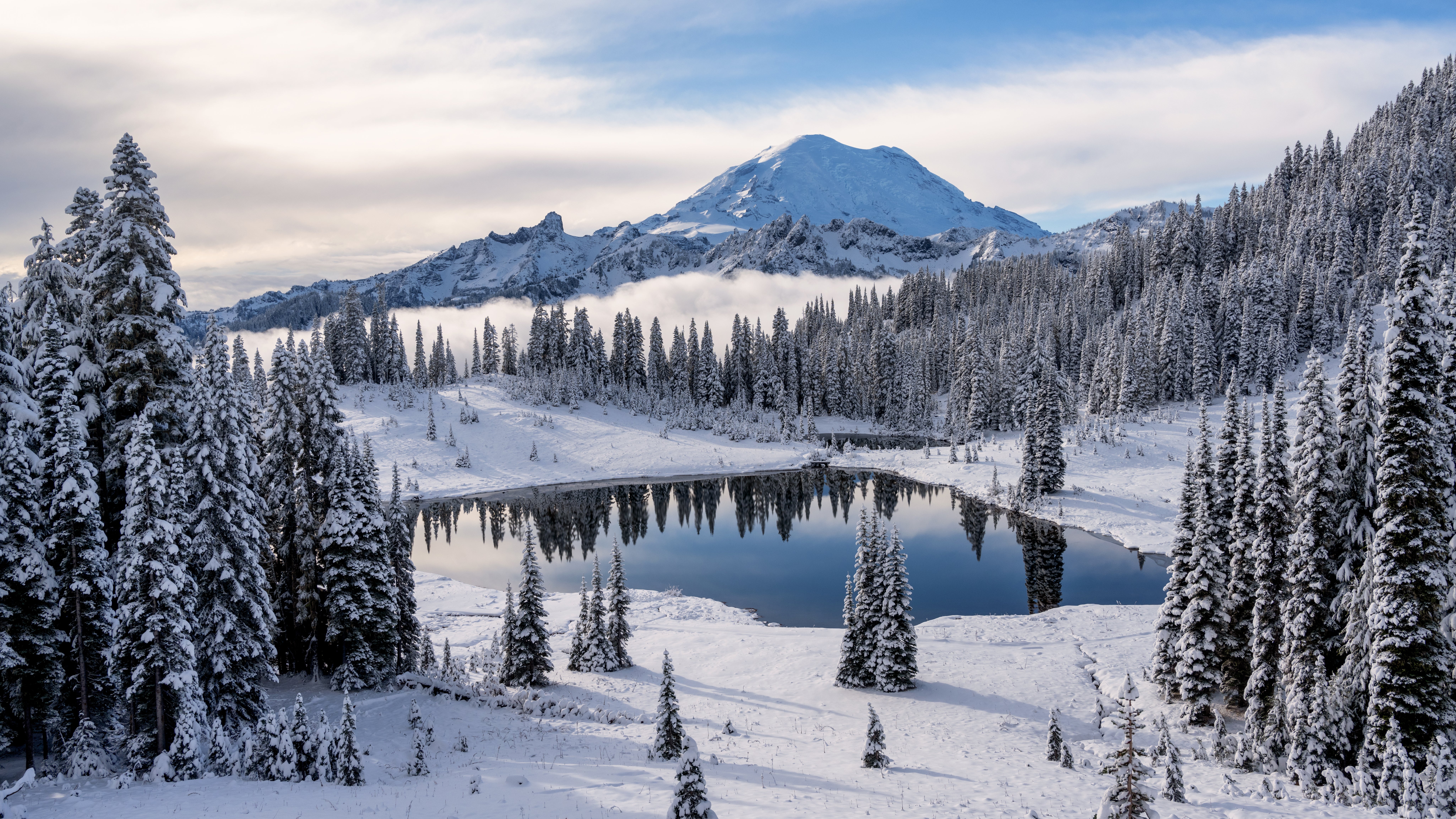 Scenic view of snow covered mountains against sky at Mount Rainier National Park.