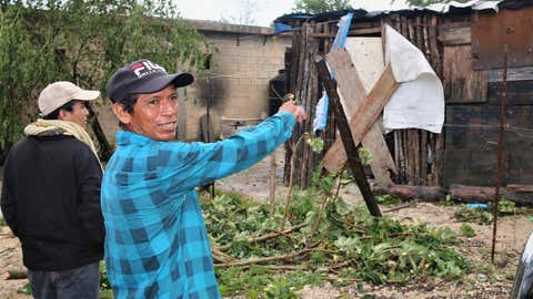 A resident points at his house that needed to be boarded up after Grace hit Tulum, Mexico, as a Category 1 hurricane on August 19, 2021. (Medios y Media/Getty Images)