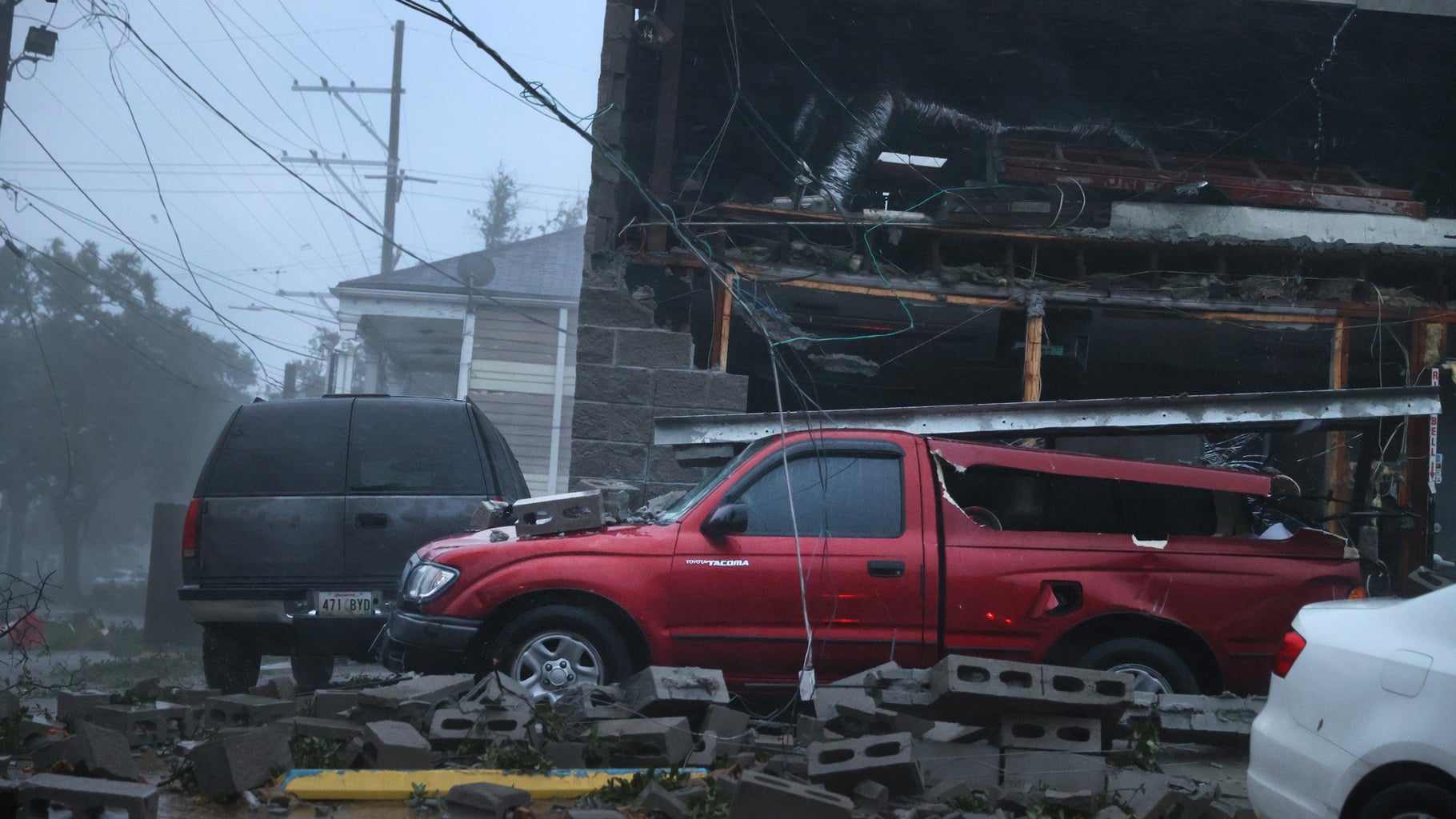 Vehicles are damaged after the front of a building collapsed during Hurricane Ida on Sunday, Aug. 29, 2021, in New Orleans, Louisiana. (Scott Olson/Getty Images)