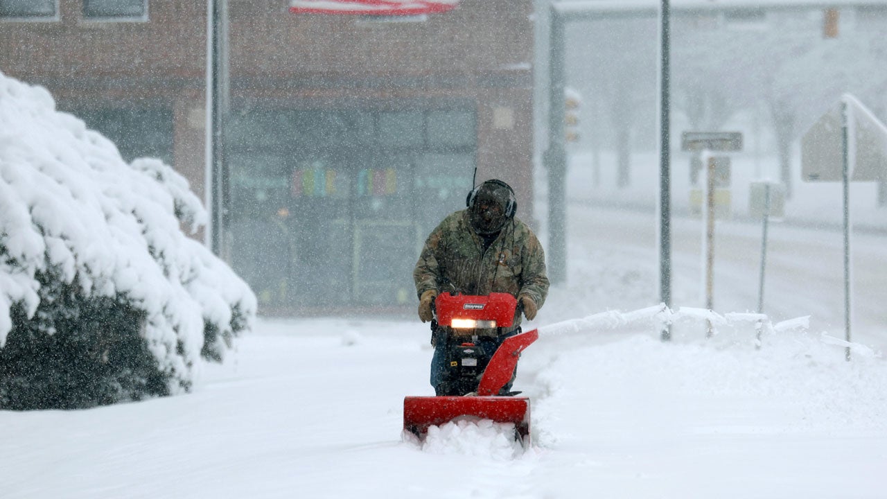 A person uses a snowblower to clear a sidewalk as a snowstorm hits the area on Tuesday, Jan. 9, 2024, in Des Moines, Iowa. (Photo by Joe Raedle/Getty Images)