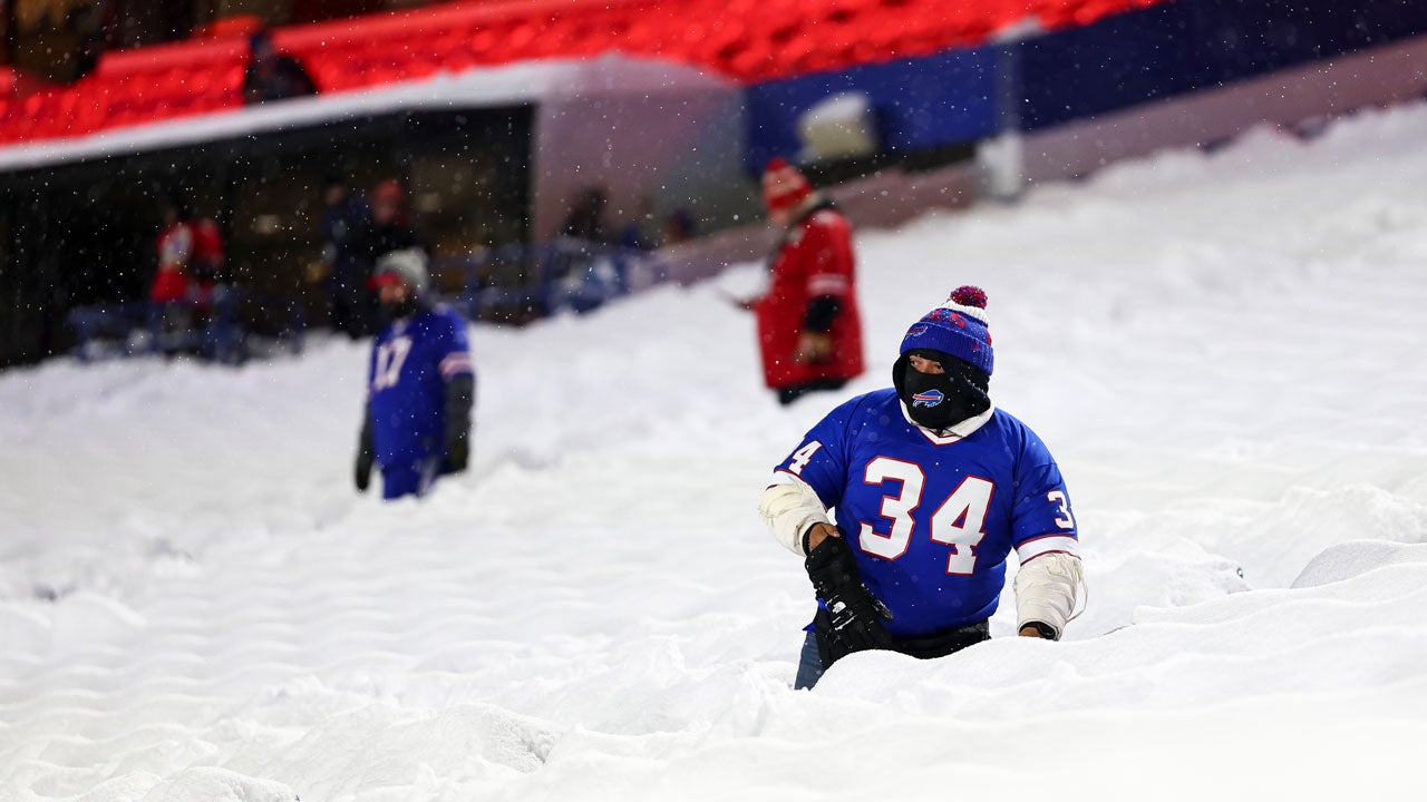 Buffalo Bills fans clear snow from seats prior to an NFL football game between the Buffalo Bills and the San Francisco 49ers at Highmark Stadium on Dec. 1, 2024, in Orchard Park, New York. (Photo by Kevin Sabitus/Getty Images)