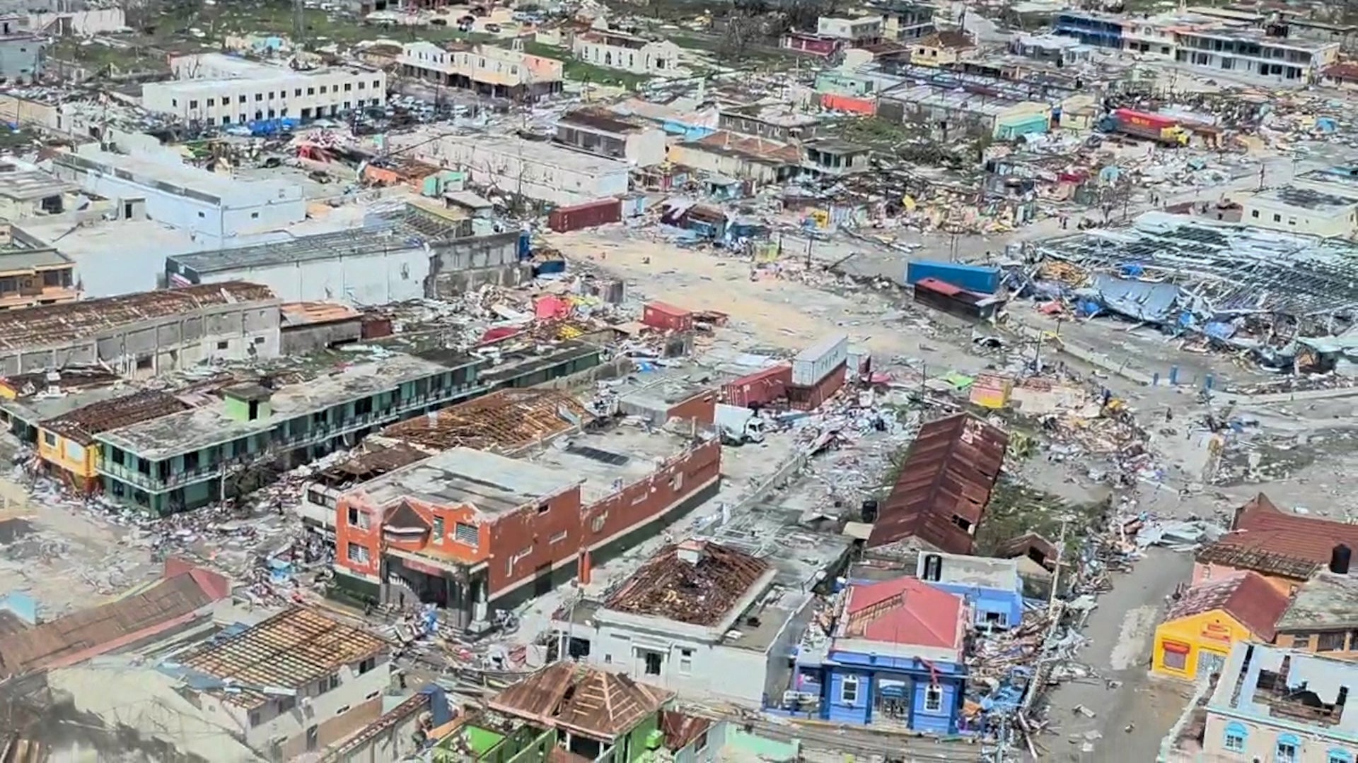 This screen grab from an aerial video shows damaged buildings and structures in St. Elizabeth Parish, Jamaica, on October 29, 2025, after Hurricane Melissa tore through the island. Hurricane Melissa ripped up trees and knocked out power after making landfall in Jamaica on October 28, 2025 as one of the most powerful hurricanes on record, inundating the island nation with rains that threaten flash floods and landslides. (Photo by Ivan Shaw / AFP)