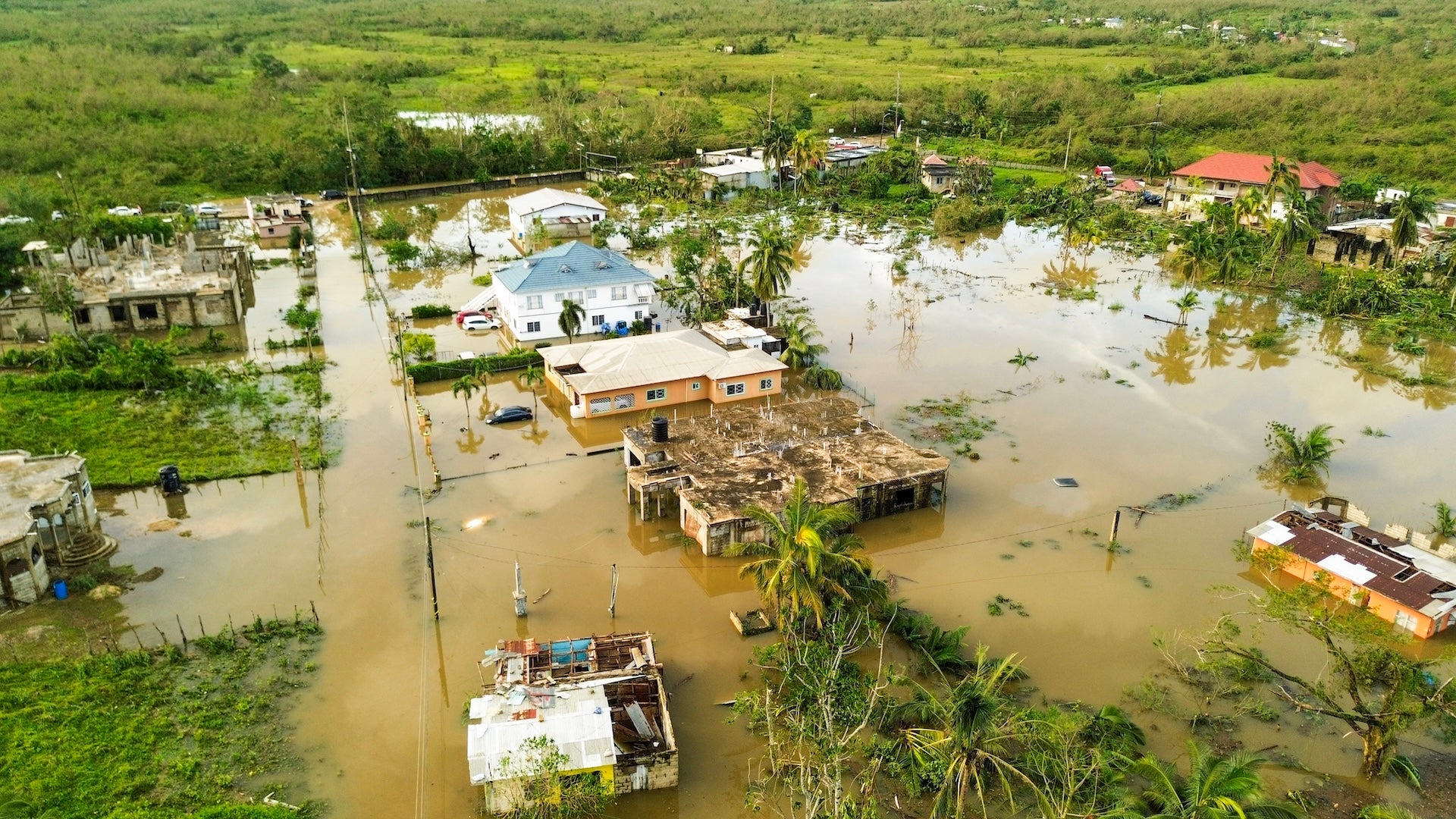 An aerial view dated October 29, 2025 shows a flooded Wilton Community following the passage the previous day of Hurricane Melissa, in St. Elizabeth, Jamaica. Hurricane Melissa bore down on the Bahamas October 29 after cutting a path of destruction through the Caribbean, leaving 30 people dead or missing in Haiti and parts of Jamaica and Cuba in ruins. Somewhat weakened but still threatening, Melissa will bring damaging winds and flooding rains to the Bahamas Wednesday before moving on to Bermuda late Thursday, according to the US National Hurricane Center (NHC). (Photo by Ricardo Makyn / AFP)