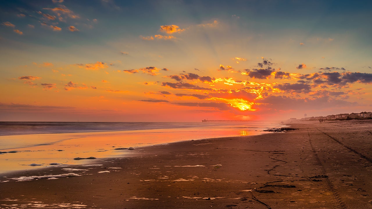 A panoramic view of the beautiful beach resort in Oak Island, N.C. North Carolina&rsquo;s Brunswick Islands have the rare distinction of running east-west as they parallel the shore. Beginning in late fall, this orientation means that you can sit on Oak Island, Ocean Isle or Holden Beach and watch both the sunrise and sunset. (Getty Images) 