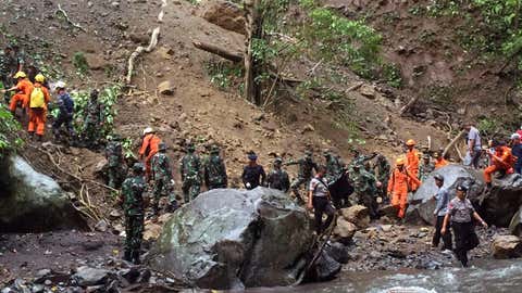 Indonesian soldiers and rescue team members search for earthquake victims in Bayan, North Lombok, Indonesia, on Monday, March 18, 2019. Officials say an earthquake triggered a landslide that hit a popular waterfall on Indonesia's Lombok island. (AP Photo/Bimbo)