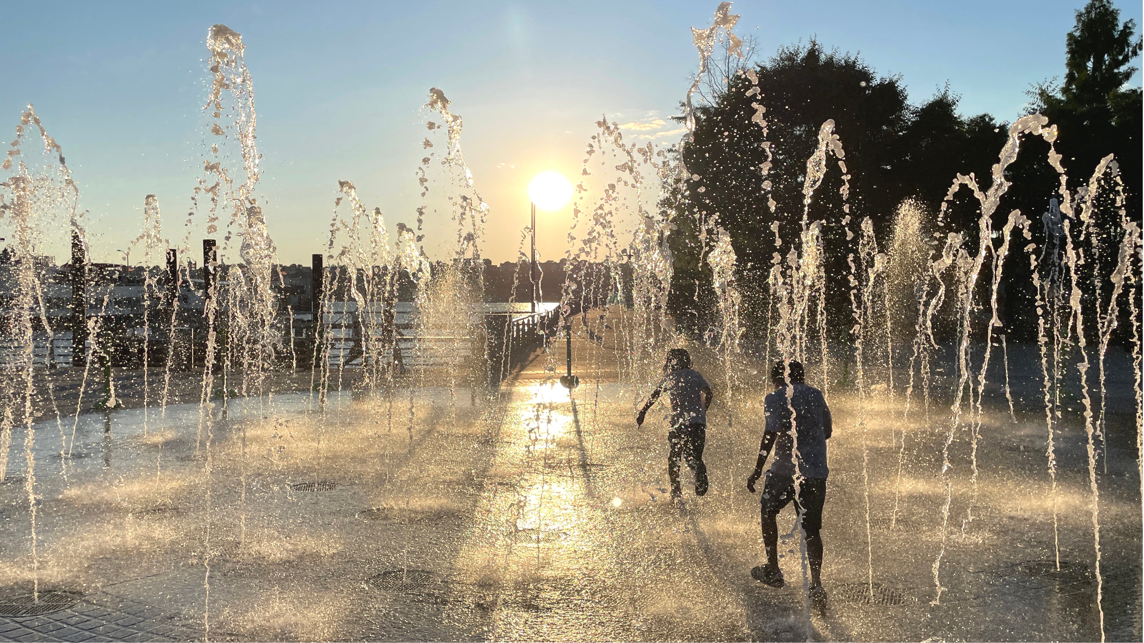 Boys having fun and getting wet as they run through a fountain to cool off in the high Summer temperatures in New York City during a heat wave. The fountain is on Pier 84 on the Hudson River near the Circle Line boats. (Photo by: Deb Cohn-Orbach/UCG/Universal Images Group via Getty Images)