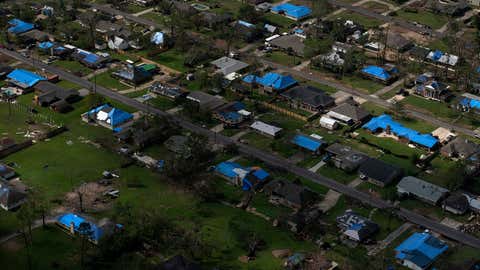 Blue tarps cover the roofs of homes in Lake Charles, Louisiana, that were damaged after Hurricane Laura and Hurricane Delta. The city's mayor says, “The plight of the average homeowner in Lake Charles is unthinkable at this moment." (Photo by Callaghan OHare for The Washington Post via Getty Images)