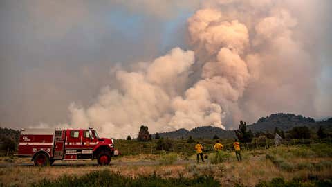 Firefighters monitor the scene as the Lava Fire continues to burn in Weed, California, on July 1, 2021. (Photo by JOSH EDELSON/AFP via Getty Images)
