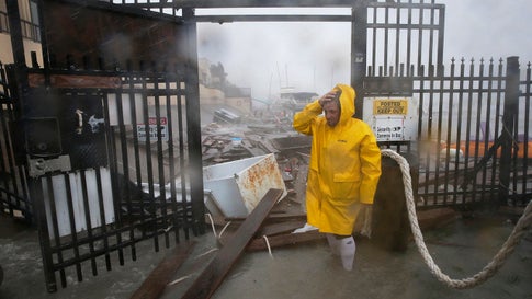 Jame Rowles examines the damage after the docks at the marina where his boat was secured were destroyed as Hurricane Hanna made landfall, Saturday, July 25, 2020, in Corpus Christi, Texas. (AP Photo/Eric Gay)