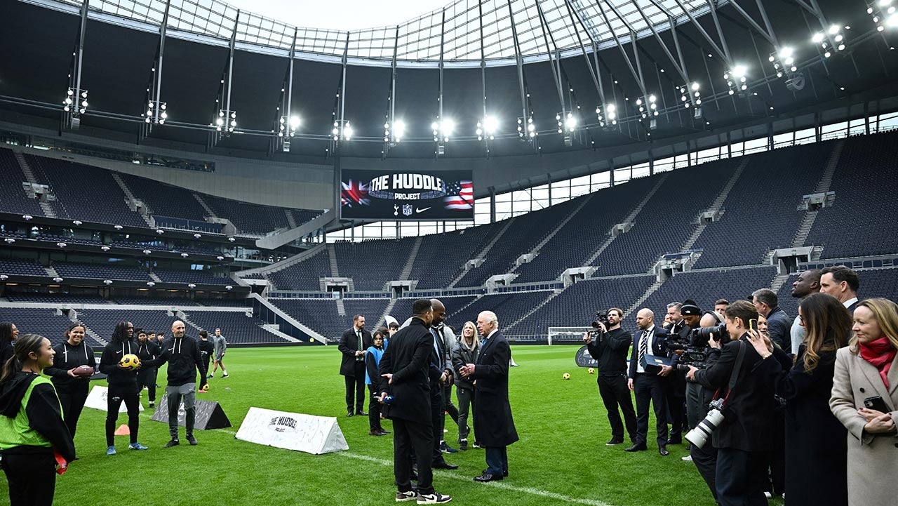 Britain's King Charles III speaks with sports personalities during a visit at Tottenham Hotspur Stadium, in London, on February 12, 2025 to learn about the charity work done in partnership between Tottenham Hotspur FC and the National Football League (NFL) for the local community. 