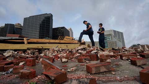 New Orleans firefighters assess damage on Monday, August 30, 2021, as they look through debris where a building collapsed from the effects of Hurricane Ida in New Orleans. (AP Photo/Eric Gay)