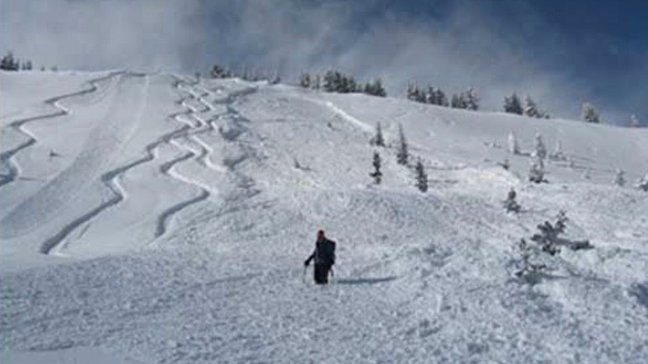 Small storm-slab avalanche surrounding a skier