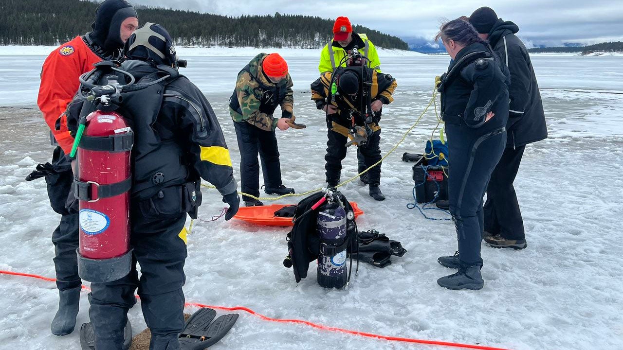 Divers prepare to enter an icy lake in Baker County, Oregon, as they search for the body of ice fisherman Mark Norenberg on Jan. 27, 2023. Norenberg is one of several people to die in the U.S. this winter in ponds or lakes covered with thin ice. (Baker County Sheriff's Office via Facebook)