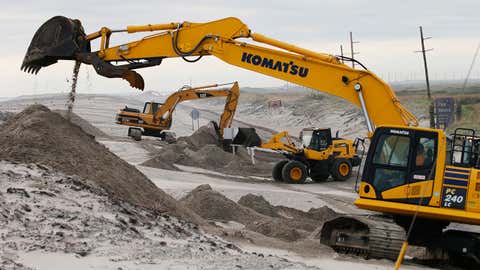 North Carolina Division of highways crews work to clear the beach road to Hatteras Island, N.C., Saturday, Sept. 7, 2019.  Dorian crossed the Outer Banks yesterday. (AP Photo/Steve Helber)