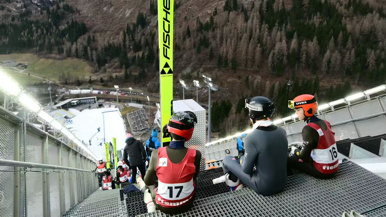Athletes train at the ski jumping arena prior to the Open Italian Championship in Predazzo, a 2026 Winter Olympics venue, on Dec. 23, 2025. (Stefano Rellandini/AFP via Getty Images)