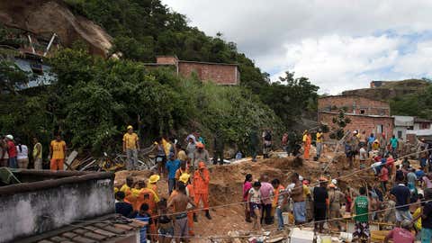 Residents, volunteers and firefighters search the debris after a mudslide in Boa Esperanca or "Good Hope" shantytown in Niteroi, Brazil, on Saturday, Nov. 10, 2018. (AP Photo/Leo Correa)