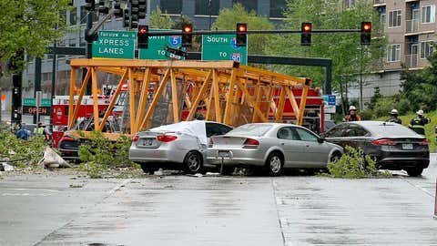 A construction crane fell into eastbound and westbound Mercer Street near Fairview Avenue East Saturday, April 27, 2019, in Seattle. Several people were killed and others wounded when a construction crane collapsed in downtown Seattle, pinning cars underneath. (Greg Gilbert/The Seattle Times via AP)