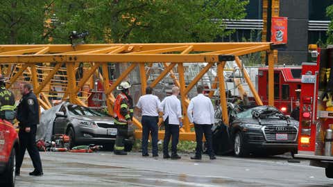 Emergency crews work at the scene of a construction crane collapse near the intersection of Mercer Street and Fairview Avenue near Interstate 5 Saturday, April 27, 2019, in Seattle. Several people were killed and others wounded when the crane collapsed Saturday afternoon in downtown Seattle, pinning cars underneath. (Alan Berner/The Seattle Times via AP)