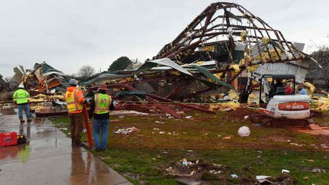 Workers begin cleanup at the George Elementary School gym Wednesday, March 30, 2022 in Springdale, Ark. (Flip Putthoff/The Northwest Arkansas Democrat-Gazette via AP)