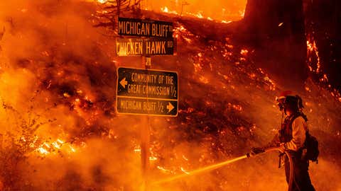 Firefighters battle a burning mosquito fire near the Michigan Bluff community in unincorporated Placer County, California, Wednesday, Sept. 7, 2022. (AP Photo/Noah Berger)