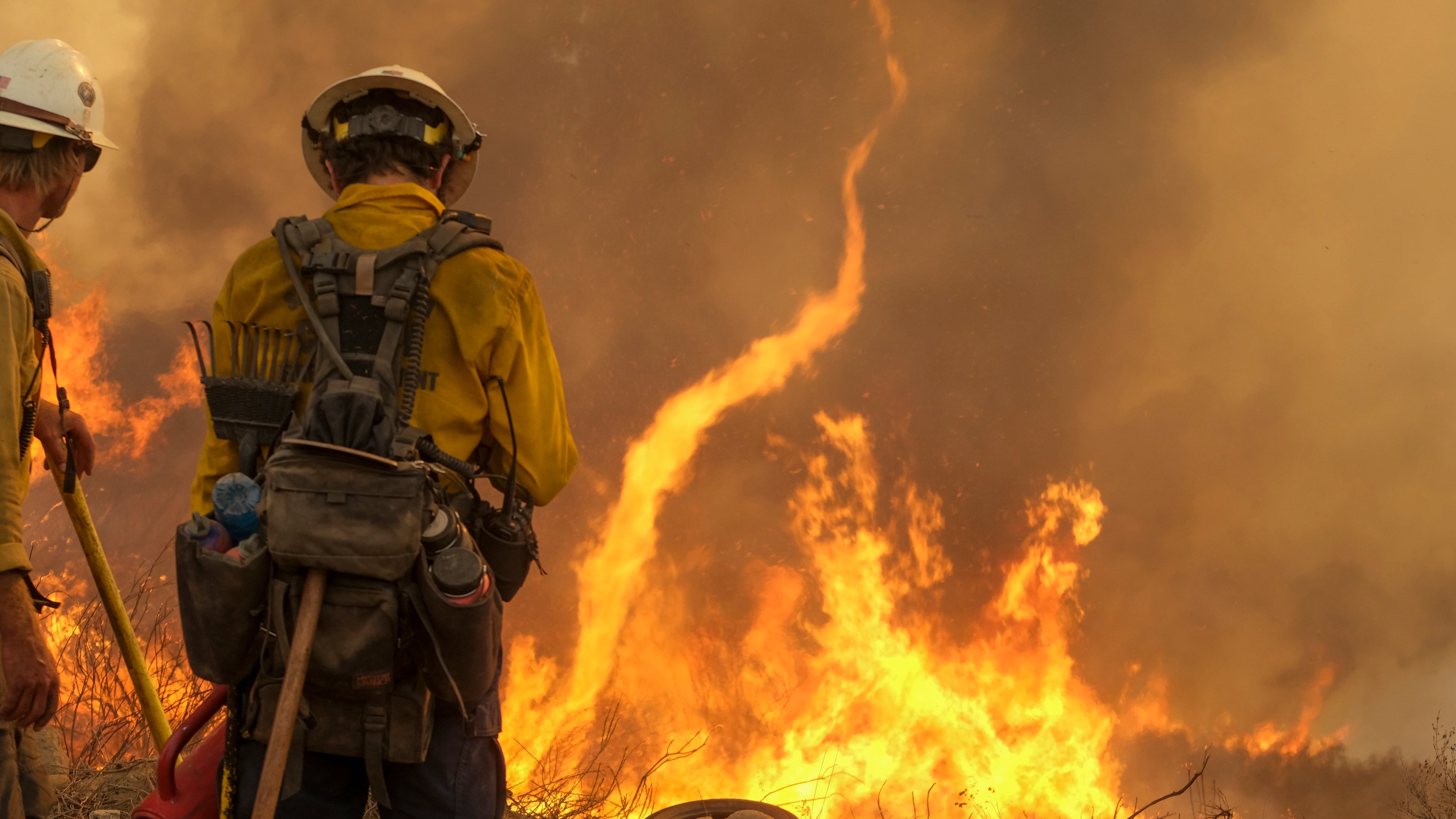 Firefighters watch as the Fairview Fire burns on a hillside Thursday, Sept. 8, 2022, near Hemet, Calif. (AP Photo/Ringo H.W. Chiu)