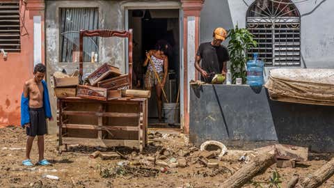 Neighbors work to recover their belongings after flooding caused by Hurricane Fiona in the Los Sotos neighborhood of Higüey, Dominican Republic, Tuesday, September 20, 2022. (AP Photo/Ricardo Hernandez)